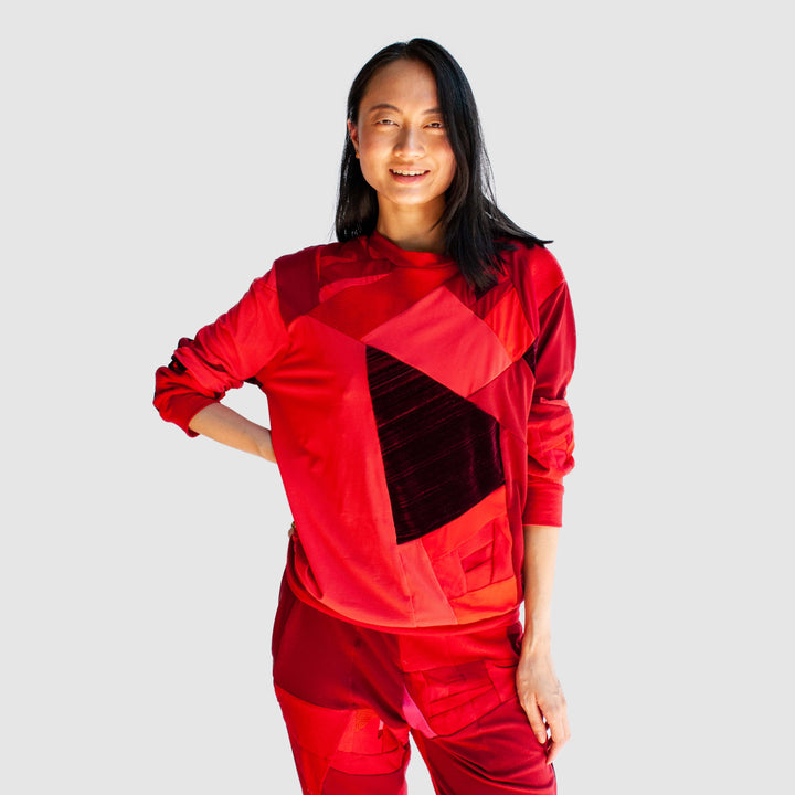 red 'all-over reroll' sweatshirt