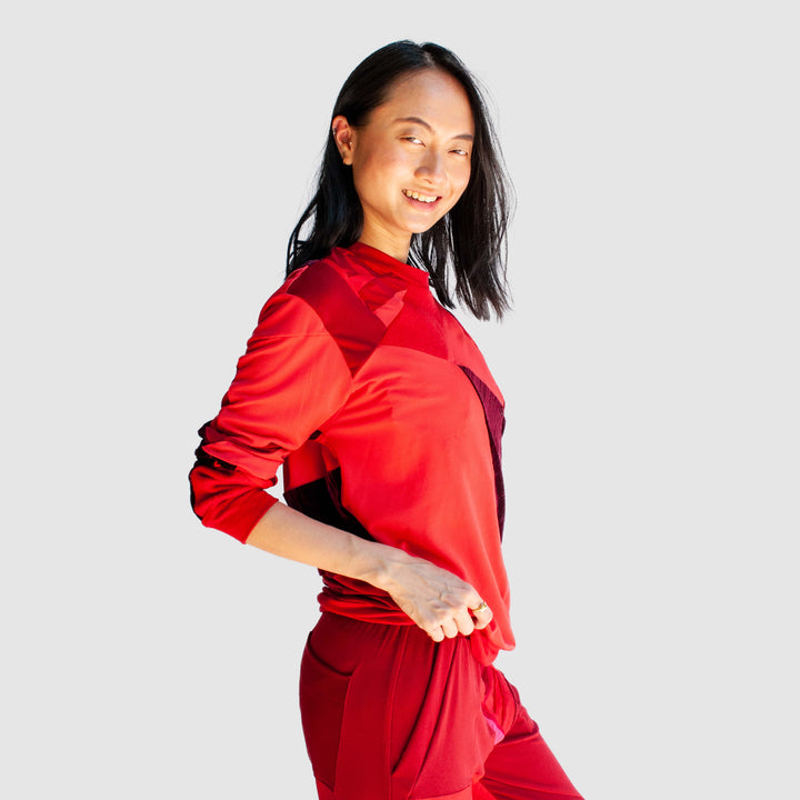 red 'all-over reroll' sweatshirt